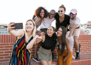 Group of people using Noz sunscreen while taking a fun picture outside.